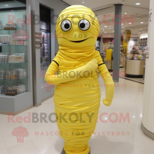 Lemon Yellow Mummy mascot costume character dressed with a Empire Waist Dress and Keychains