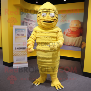 Lemon Yellow Mummy mascot costume character dressed with a Empire Waist Dress and Keychains