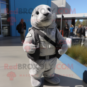 Gray Seal mascot costume character dressed with a Moto Jacket and Backpacks