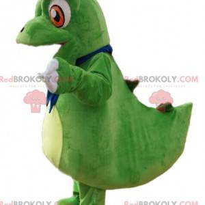 Mascotte piccolo dinosauro verde con grandi occhi arancioni -