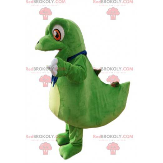 Mascotte piccolo dinosauro verde con grandi occhi arancioni -