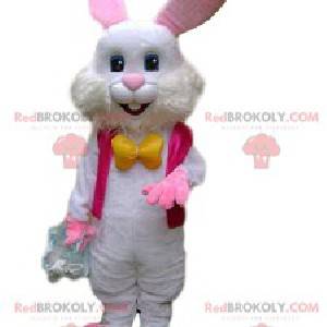 Mascotte coniglio bianco con una giacca fucsia e un fiocco