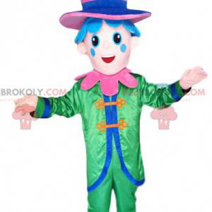 Smiling character mascot with a green costume and a pink hat -