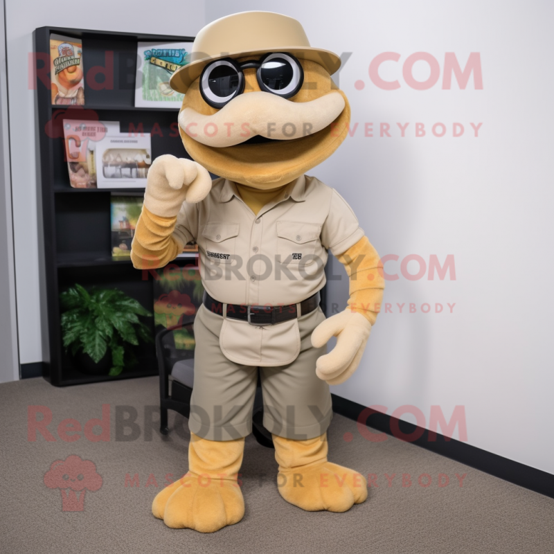 Tan Titanoboa mascot costume character dressed with a Overalls and Reading glasses Tan Titanoboa mascot costume character dressed with a Overalls and Reading glasses