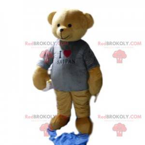 Mascotte dell'orso bruno con una maglietta grigia -