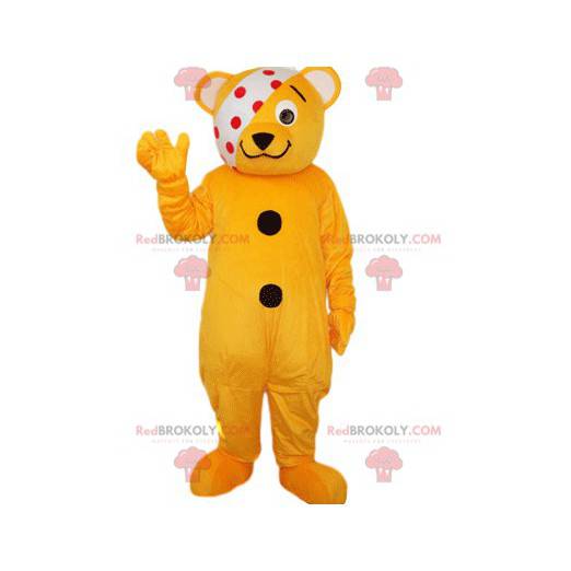 Mascota oso naranja naranja con una venda blanca con puntos