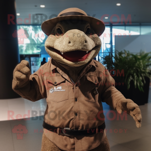 Brown Komodo Dragon mascot costume character dressed with a Leather Jacket and Hat pins