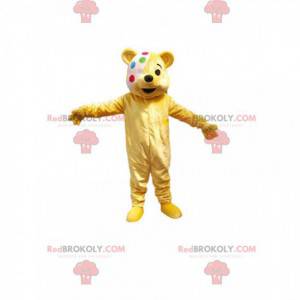 Mascote ursinho amarelo com bandagem multicolorida -