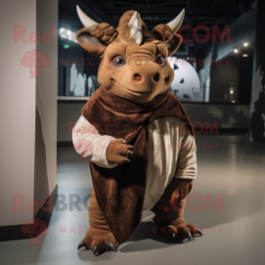 Brown Triceratops mascot costume character dressed with a T-Shirt and Shawl pins