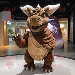 Brown Triceratops mascot costume character dressed with a T-Shirt and Shawl pins