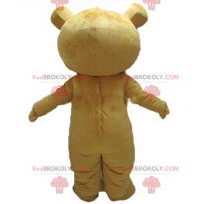 Mascote urso de pelúcia amarelo e branco muito sorridente -
