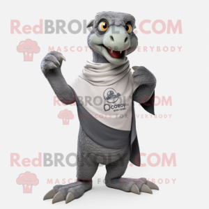 Gray Deinonychus mascot costume character dressed with a Polo Tee and Shawl pins