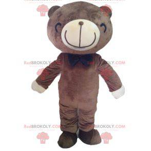 Mascotte d'ours marron et blanc avec un large sourire -