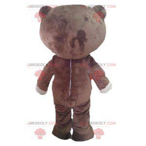 Mascotte d'ours marron et blanc avec un large sourire -