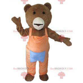 Brown and white bear mascot with orange overalls -