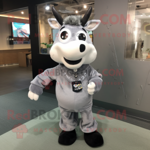 Gray Cow mascot costume character dressed with a Corduroy Pants and Bracelet watches