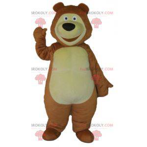 Mascote grande urso marrom e amarelo muito sorridente -