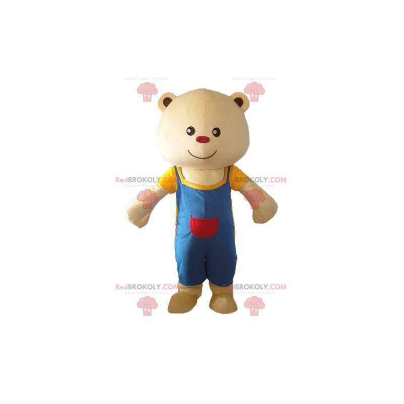 Mascotte de gros nounours beige avec une salopette bleue -