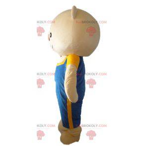 Stor beige bamse maskot med blå overall - Redbrokoly.com