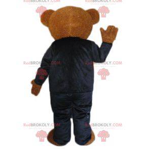 Brown teddy bear mascot dressed in a black and white costume -