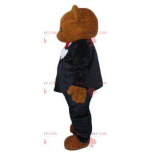 Brown teddy bear mascot dressed in a black and white costume -