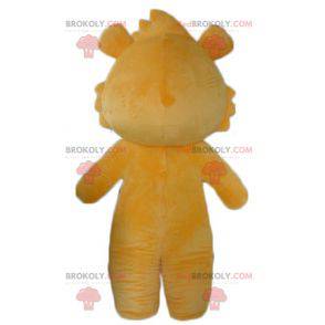 Orange and white teddy bear mascot looking mischievous -