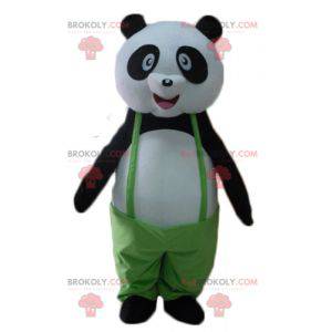 Mascotte de panda noir et blanc avec une salopette verte -