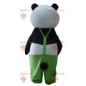 Mascotte de panda noir et blanc avec une salopette verte -