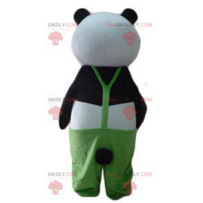 Mascotte de panda noir et blanc avec une salopette verte -