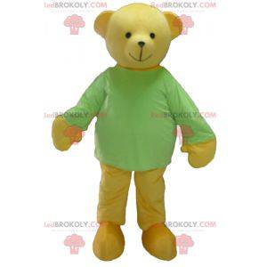 Mascota del oso de peluche amarillo con una camiseta verde -