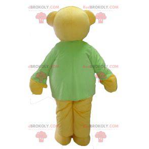 Mascote do ursinho de pelúcia amarelo com uma camiseta verde -