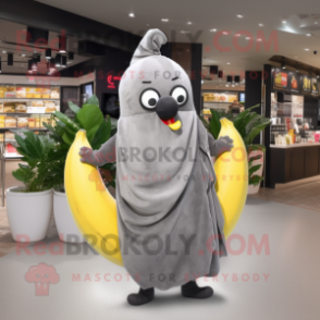 Gray Banana mascot costume character dressed with a T-Shirt and Shawl pins