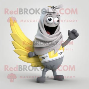 Gray Banana mascot costume character dressed with a T-Shirt and Shawl pins