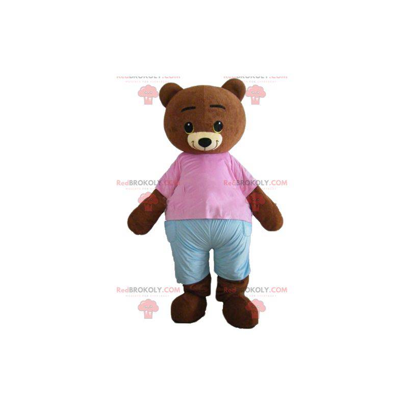 Lille brun bjørnemaskot brun med en lyserød og blå tøj -