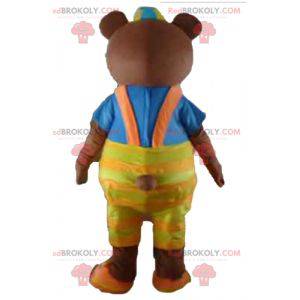 Brown bear mascot with yellow overalls and a t-shirt -