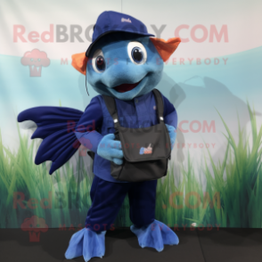 Navy Betta Fish mascot costume character dressed with a Dungarees and Messenger bags