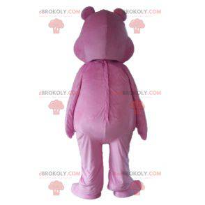 Pink Care Bear mascot with a rainbow on the stomach -