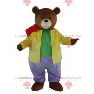 Brun bjørnemaskot klædt i et meget farverigt tøj -