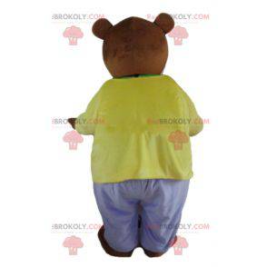 Brun bjørnemaskot klædt i et meget farverigt tøj -