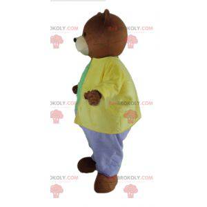 Mascotte orso bruno vestito con un abito molto colorato -