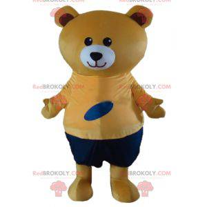 Mascote grande urso de pelúcia bege com roupa laranja e azul -