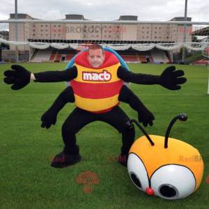 Mascotte d'insecte jaune rouge bleu et noir de coccinelle -