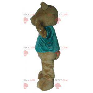 Mascota del oso de peluche marrón con una camiseta verde -