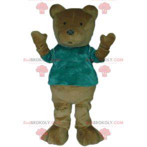 Mascota del oso de peluche marrón con una camiseta verde -