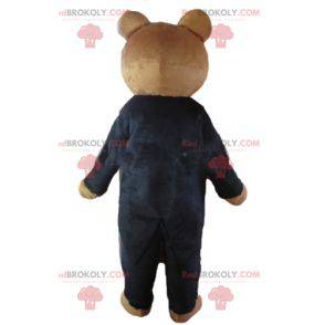 Brown Teddybär Maskottchen in einem schwarzen Kostüm gekleidet