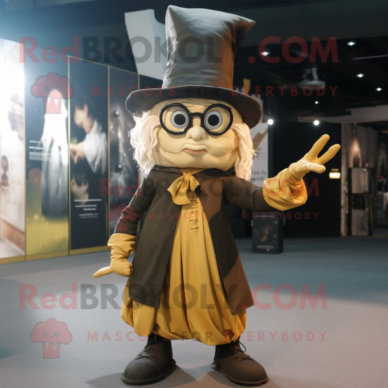 Gold Witch mascot costume character dressed with a Oxford Shirt and Eyeglasses Gold Witch mascot costume character dressed with a Oxford Shirt and Eyeglasses