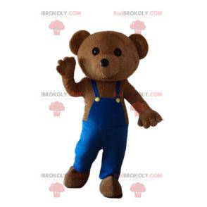 Mascotte d'ours en peluche avec une salopette bleue -
