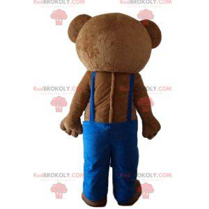 Mascotte d'ours en peluche avec une salopette bleue -