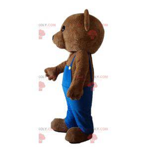 Mascotte d'ours en peluche avec une salopette bleue -