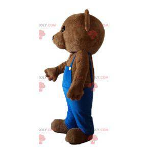 Mascotte d'ours en peluche avec une salopette bleue -